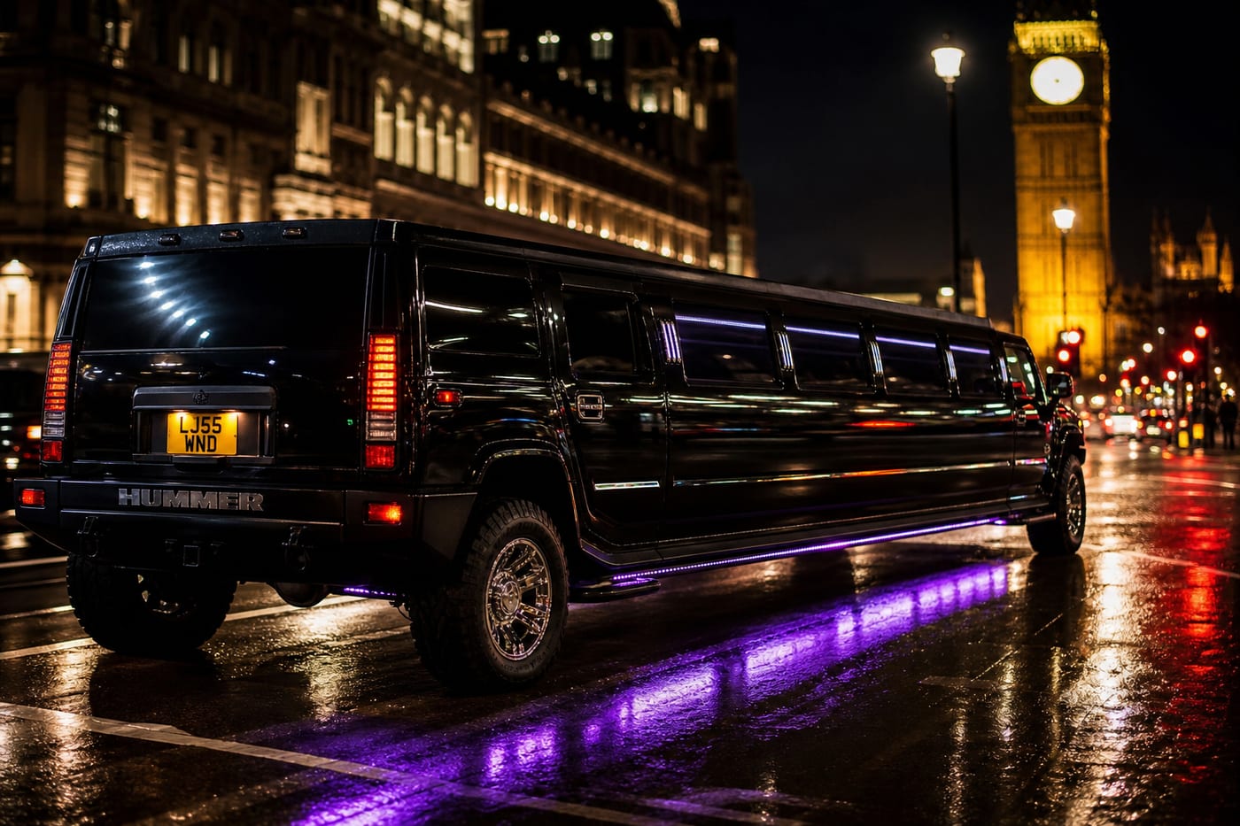 Black stretch Hummer H2 limousine at night in London — party limousine hire UK