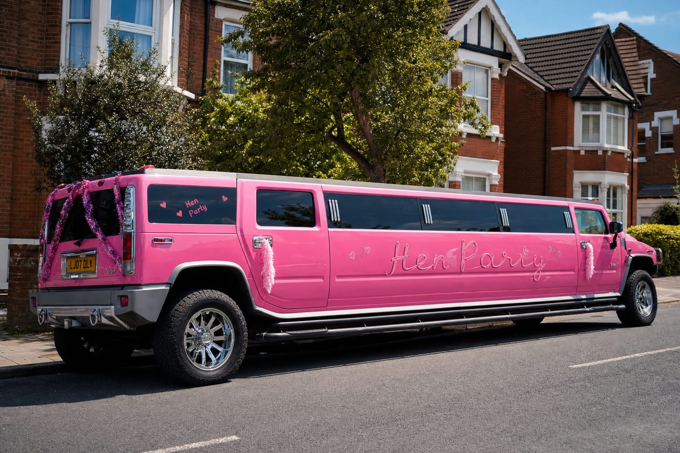 Pink stretch Hummer limousine for hen party hire on a UK street